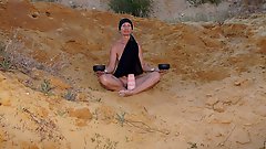 On sand seminude with light-color vase
